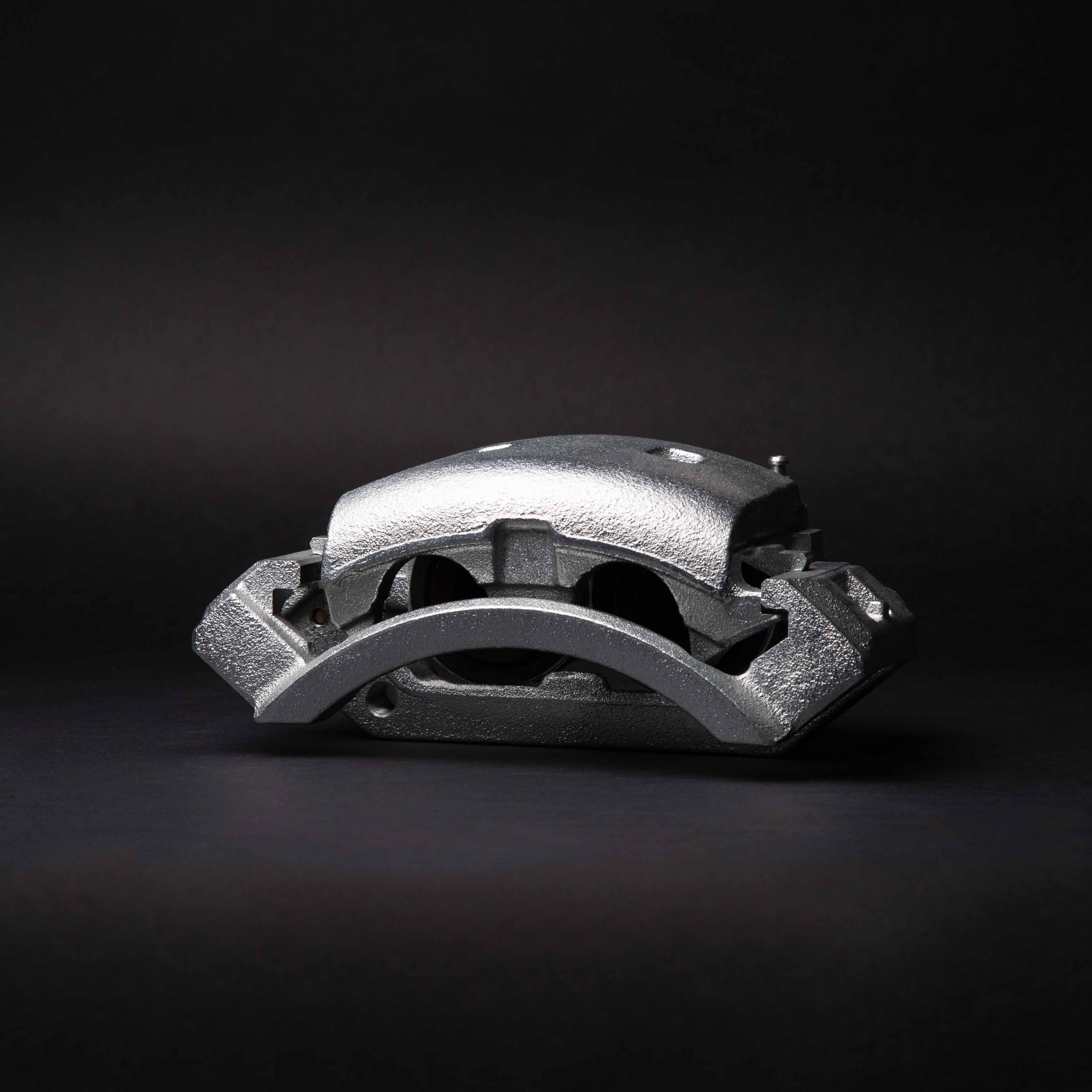 A bare brake caliper casting, studio lit on black - Spongy Brake Pedal: What Is It
