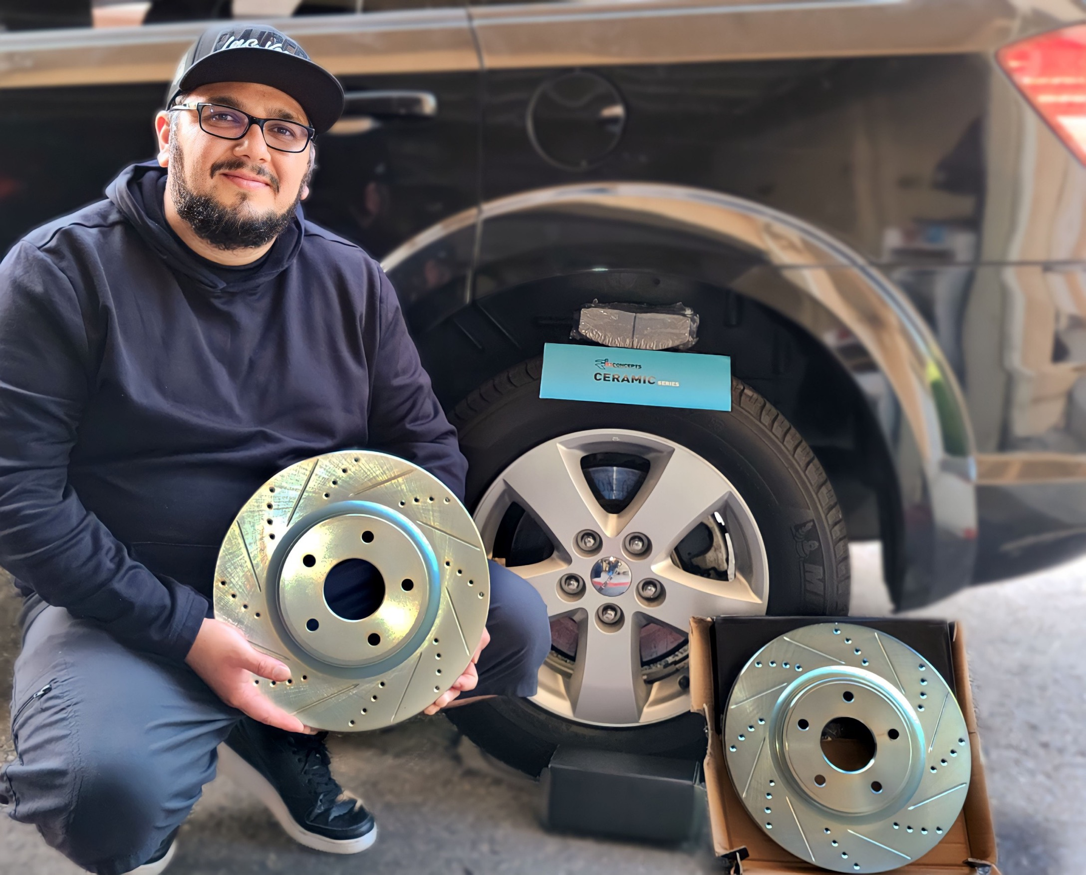 happy customer holding drilled and slotted rotors