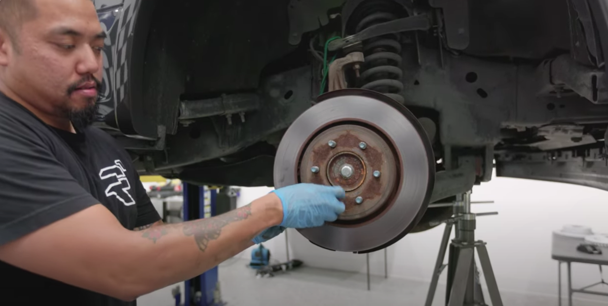 Removing old brake rotor during a DIY brake pad and rotor replacement